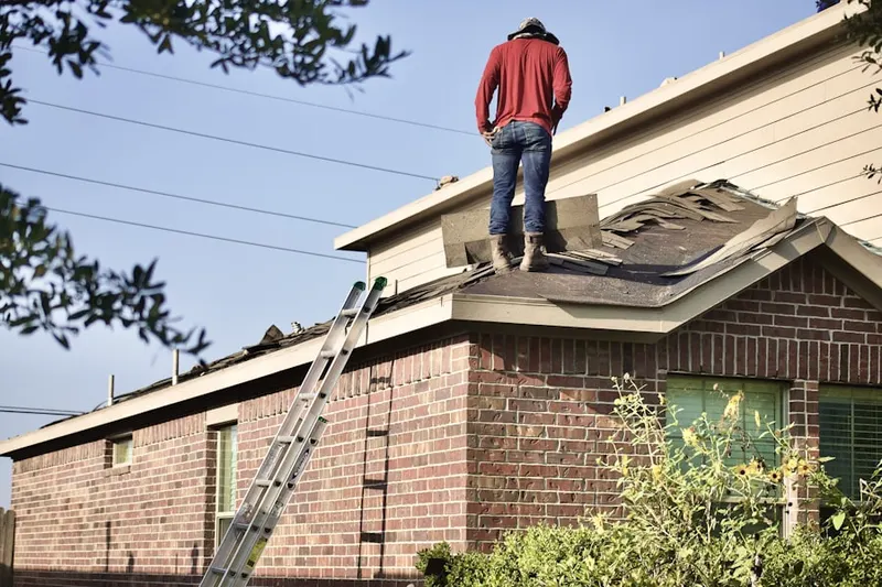 Professional roofer working on a residential roof in Shore View